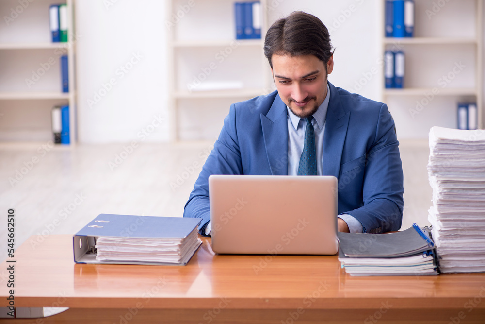 Young businessman employee and too much work in the office Young businessman employee and too much work in the office