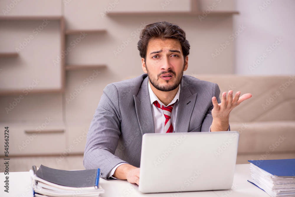 Young male employee working from home during pandemic Young male employee working from home during pandemic