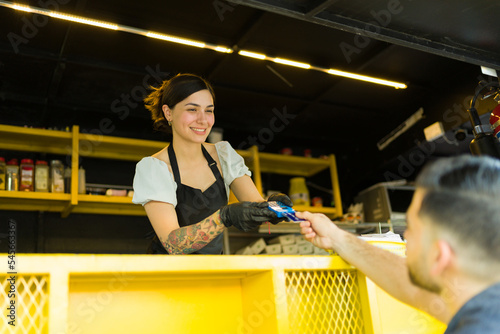 Vászonkép Beautiful food stall vendor with a customer at the food truck