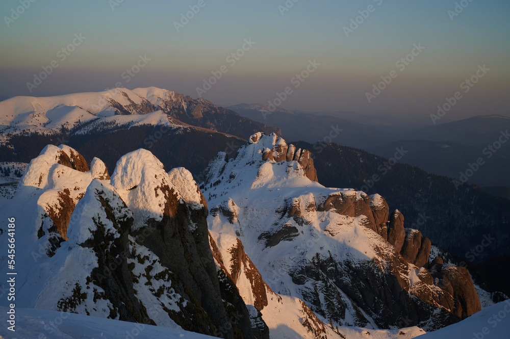 Mountain panoramic view in winter at sunset. Aerial alpine view