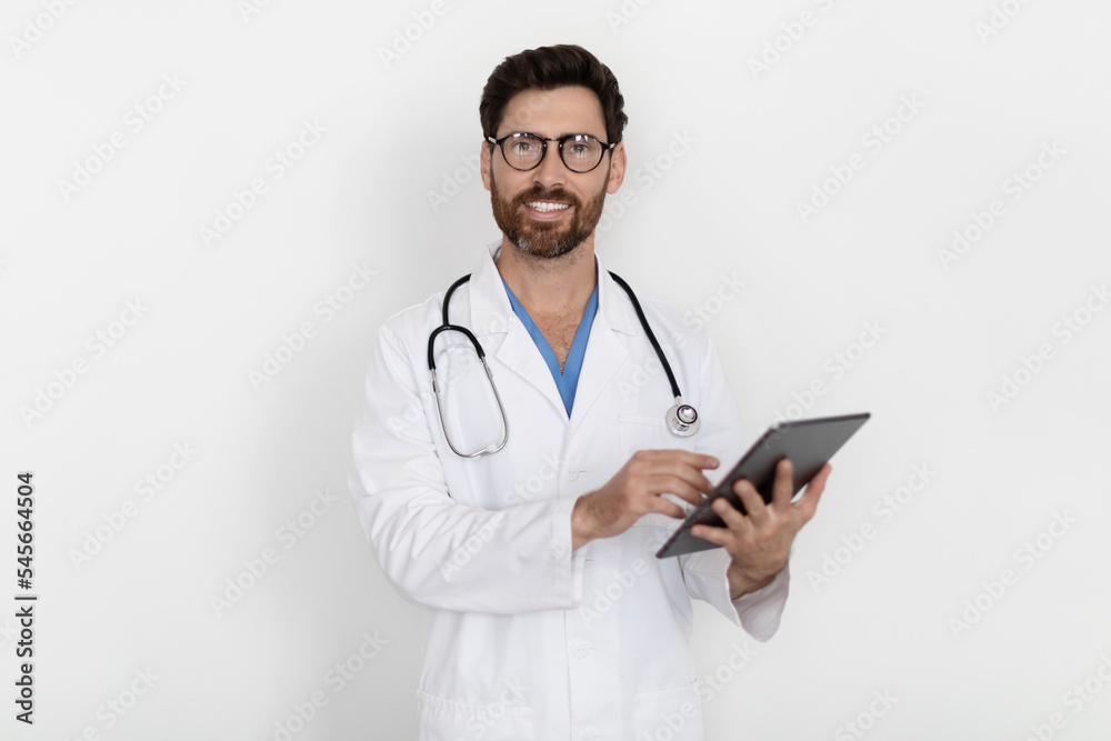 Medical Care. Handsome Smiling Doctor Man In Uniform With Clipboard In Hands Medical Care. Handsome Smiling Doctor Man In Uniform With Clipboard In Hands