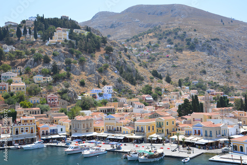 greek island Symi with boats, multicolored buildings and hills view from top © Irina