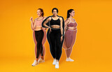 Cheerful slender european, arab and black young women athletes in sportswear, overweight ladies drawn around