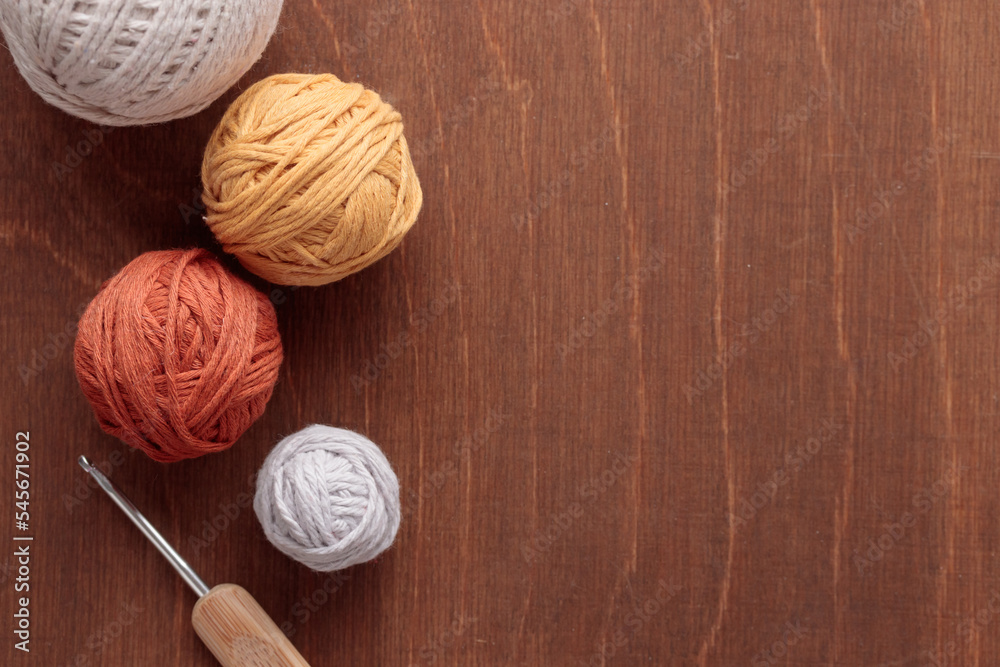 Cotton Yarn Balls for Crocheting Handmade on a Light Colored Wooden background Cotton Yarn Balls for Crocheting Handmade on a Light Colored Wooden background