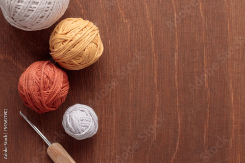 Cotton Yarn Balls for Crocheting Handmade on a Light Colored Wooden background