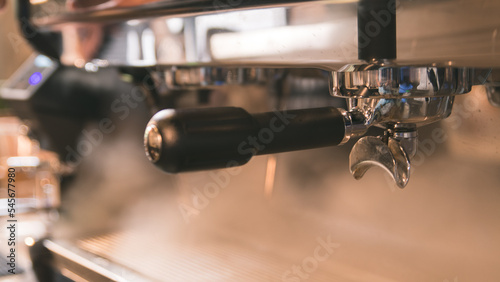 Close up of espresso coffee machine , Brewing coffee espresso shot flowing from bottomless portafilters with machine.