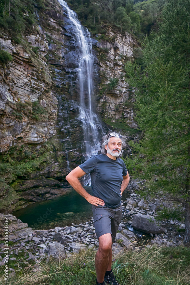 Mature man Waterfall, Sonogno, Switzerland