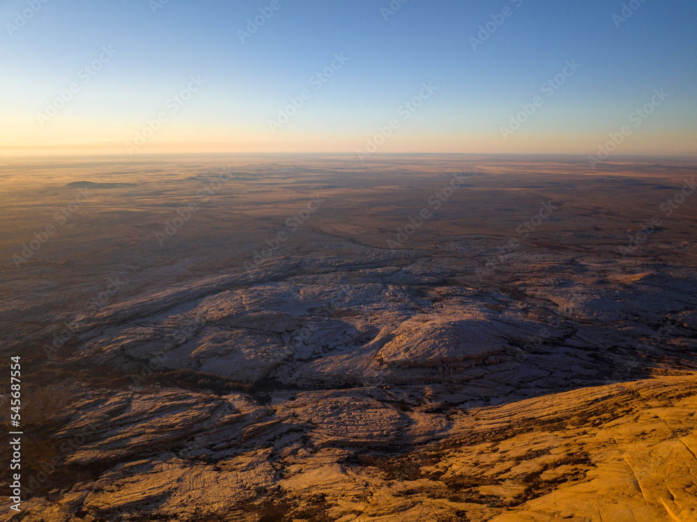 Bektau-Ata mountain range is triassic granite massif surrounded by a flat steppe. Wide-angle aerial view.