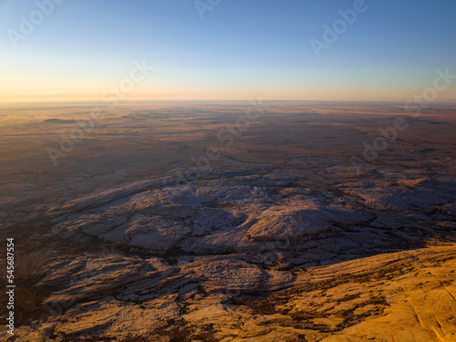 Bektau-Ata mountain range is triassic granite massif surrounded by a flat steppe. Wide-angle aerial view.