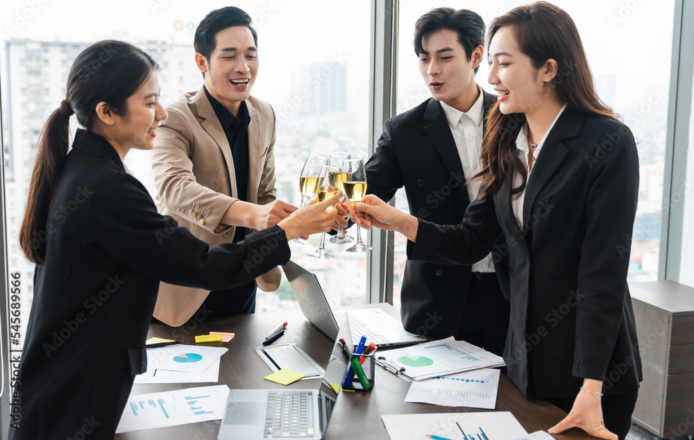 group of Asian business people holding glasses of wine to celebrate new year group of Asian business people holding glasses of wine to celebrate new year