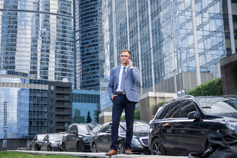 A man in a suit in full growth on the background of the business center