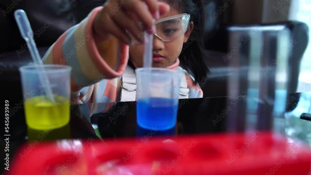 Asian children having fun doing liquid science lab experiments Asian children having fun doing liquid science lab experiments