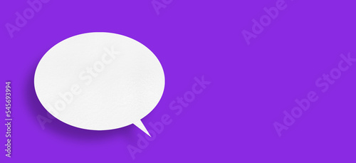 White paper in the shape of speech bubbles against a purple background. communication bubbles