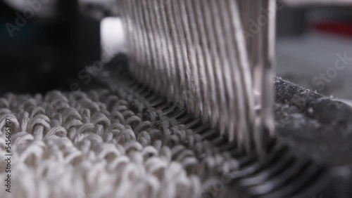 Closeup of weaving mechanism is fabricating synetic MOP