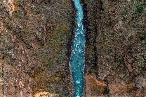 Photography Aerial top view of a narrow river between hills in the countryside