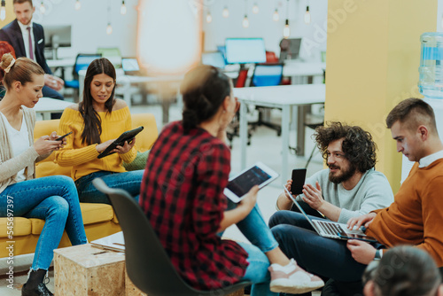 Multiethnic group of employees working in a marketing company. A group of colleagues is working on a project in modern offices