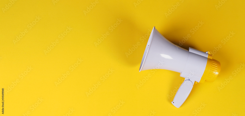 Megaphone is isolated on yellow background. Megaphone is isolated on yellow background.
