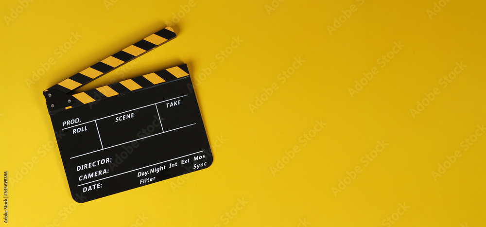 Clapper board or yellow movie slate on yellow background.