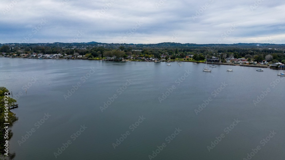 Aerial shot of Hastings River Port with scenic mountains and cloudscape in the background
