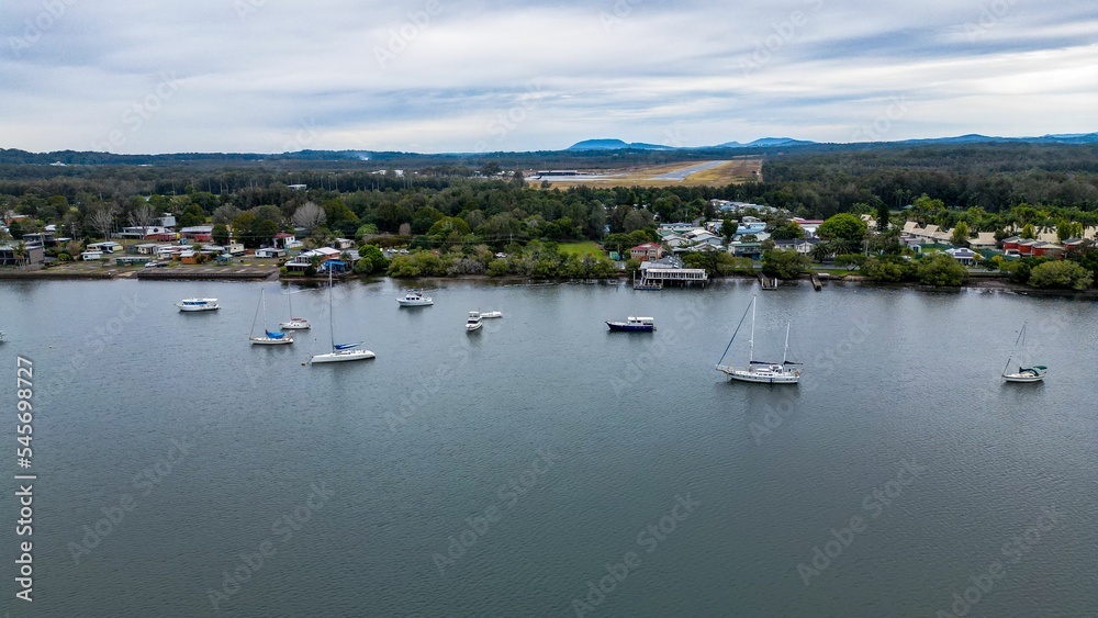 Aerial shot of Hastings River Port with scenic mountains and cloudscape in the background Aerial shot of Hastings River Port with scenic mountains and cloudscape in the background