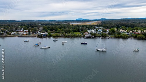 Aerial shot of Hastings River Port with scenic mountains and cloudscape in the background