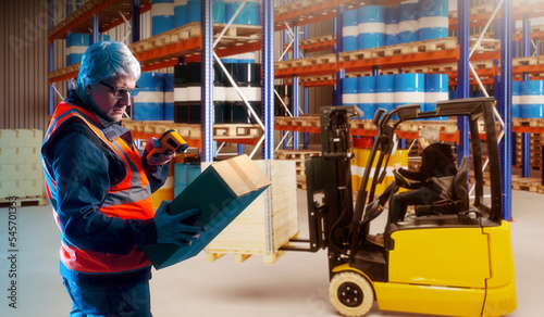 Man with scanner in warehouse. Customs clearance. Guy works as customs inspector. Man uses barcode scanner. Storage supervisor. Gray-haired customs inspector registers postal items.