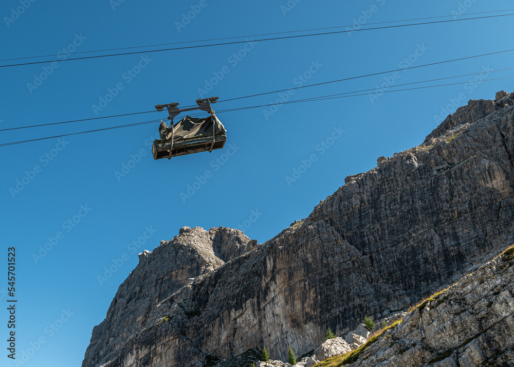 Obraz premium A device for transporting goods in mountain refuge. Cable car for carrying in the mountains Tuckett refuge - Brenta group, Vallesinella, Madonna di Camoiglio - northern Italy, august 23, 2022