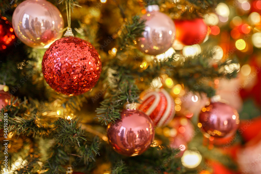 Close up of balls on christmas tree. Bokeh garlands in the background. New Year concept Close up of balls on christmas tree. Bokeh garlands in the background. New Year concept