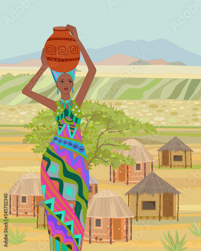 An African woman, carrying water jugs on her head, stands in fro