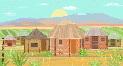 African landscape with sunrise and huts.