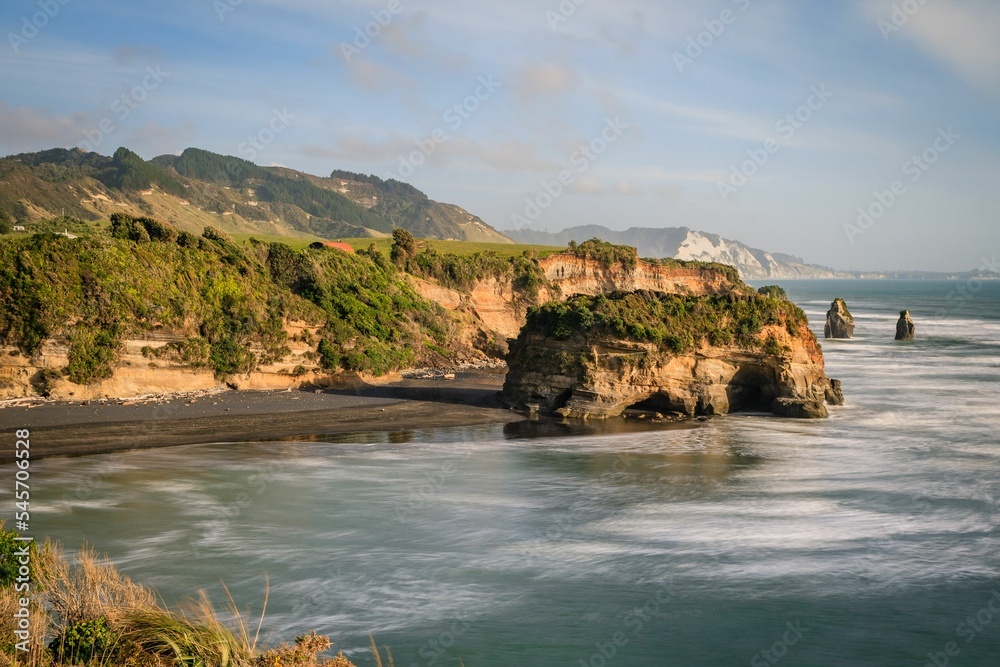 Scenic view of a The Three Sisters and the Elephant Rock beach on a hot summer day in New Zealand Scenic view of a The Three Sisters and the Elephant Rock beach on a hot summer day in New Zealand