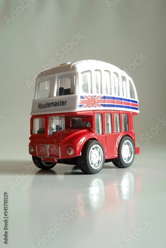 Vertical shot of a bus toy with the flag on the United Kingdom on its surface