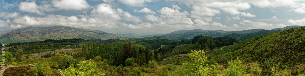 Panoramic shot of green landscapes under the cloudy sky Panoramic shot of green landscapes under the cloudy sky