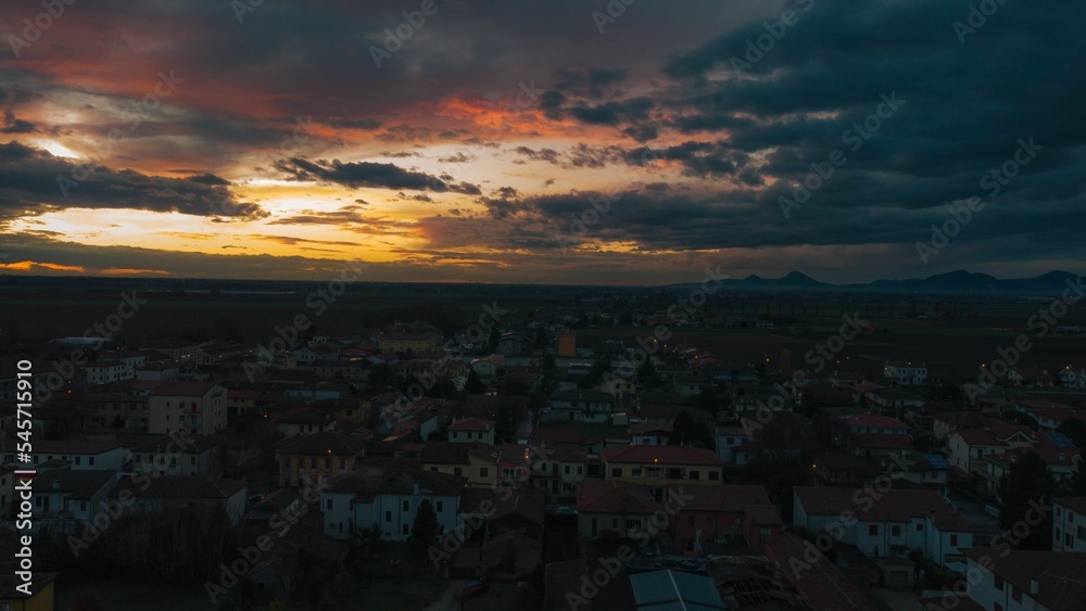 Aerial shot of the Bagnoli di Sopra commune in Italy, during an orange sunset