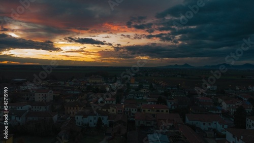 Aerial shot of the Bagnoli di Sopra commune in Italy, during an orange sunset