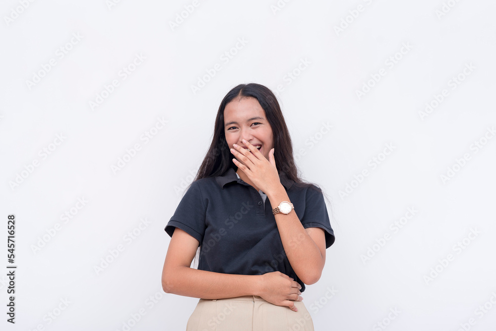 A young asian woman snickers from a joke. A happy and lighthearted scene. Isolated on a white backdrop. A young asian woman snickers from a joke. A happy and lighthearted scene. Isolated on a white backdrop.