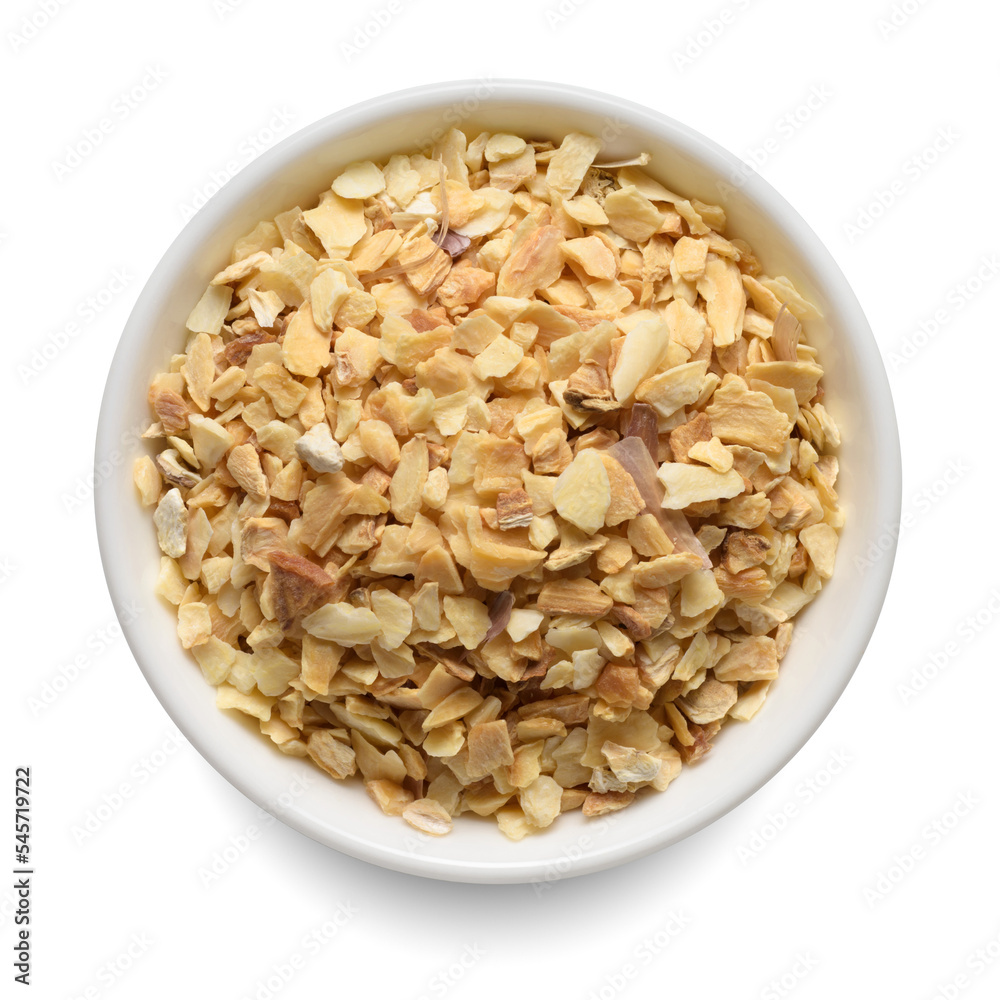 Dried garlic granules in white bowl isolated on white. Top view. Dried garlic granules in white bowl isolated on white. Top view.