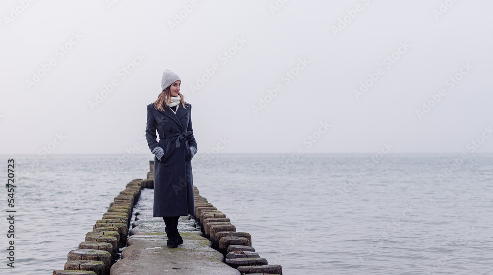 Woman on Groynes in the German Baltic Sea during winter