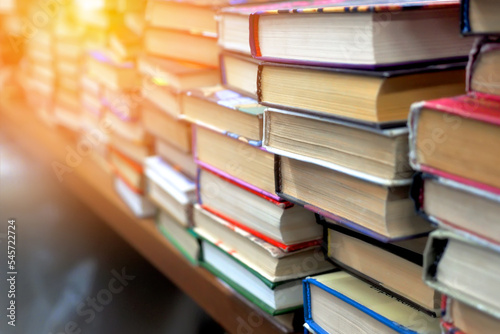 Old used books are on table in bookstore. Lot of books in stack at book flea market. Background. photo