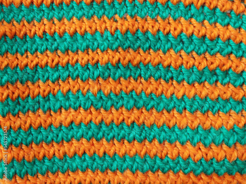 Texture of striped orange green wool knitted fabric  