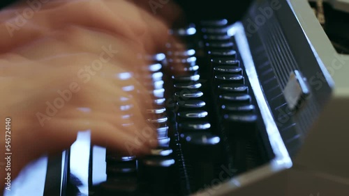 A man typing on a typewriter