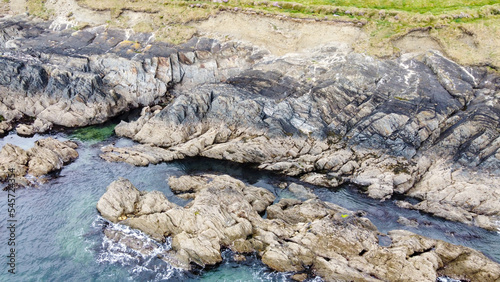 Coastal rocks under sea water, seascape. The coastline of the Atlantic Ocean, the north of Europe. Beautiful ocean water, top view. Drone photo. © Oleksii