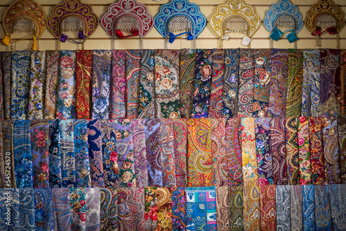 Store of Russian souvenirs: traditional women's head dresses kokoshnoks and colourful scarves