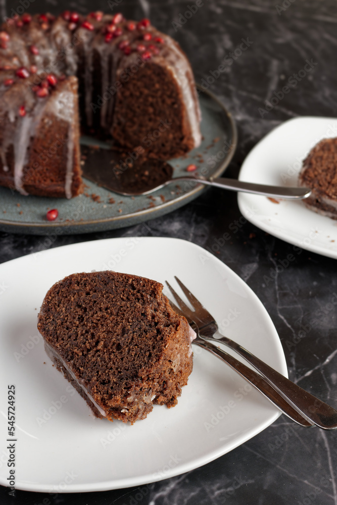 Mulled wine sponge cake with icing and pomegranate seeds. Mulled wine sponge cake with icing and pomegranate seeds.