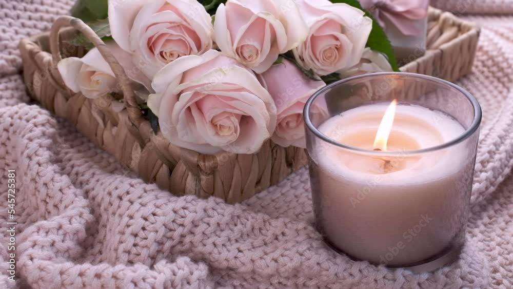 Tray with bouquet of beautiful pink roses and gift box and burning candle on bed. Tray with bouquet of beautiful pink roses and gift box and burning candle on bed.