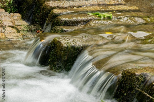 Beautiful closeup of a water flowing from the stones