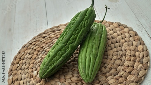 High-angle shot of bitter melons on a wicker mat photo