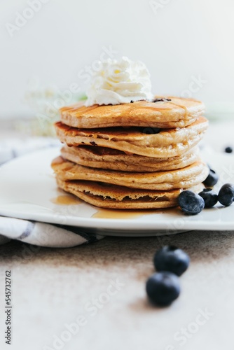 Vertical shot of Blueberry Pancakes with Whipped Cream