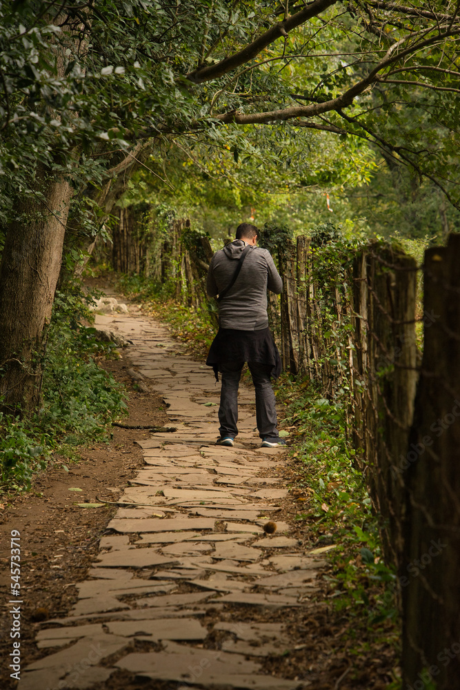 Obraz premium Adult hiker on the stone path that leads to the famous Zugarramurdi witches cave in Navarre, Spain.