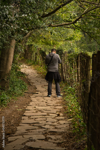 Adult hiker on the stone path that leads to the famous Zugarramurdi witches cave in Navarre, Spain. photo